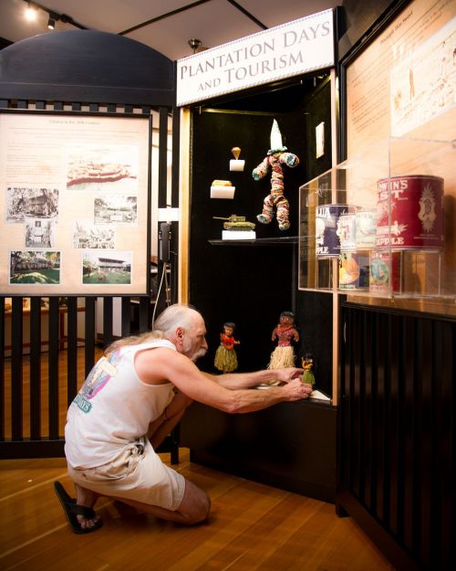 Mike Jones Installing Plantation Toys Exhibit (Photo Courtesy of Lahaina Restoration Foundation)